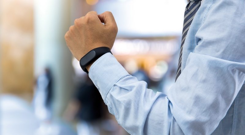 isolated business man with smart wristband